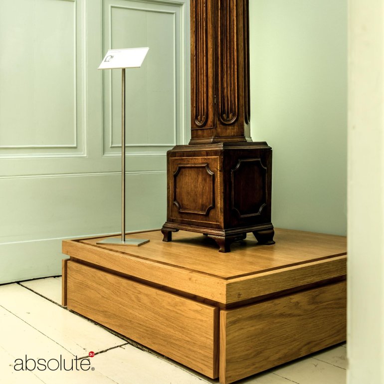 Pinnacle label holder displaying descriptive information for a museum display on wooden stand.  Pinnacle label holder displaying descriptive information for a museum display on wooden stand.